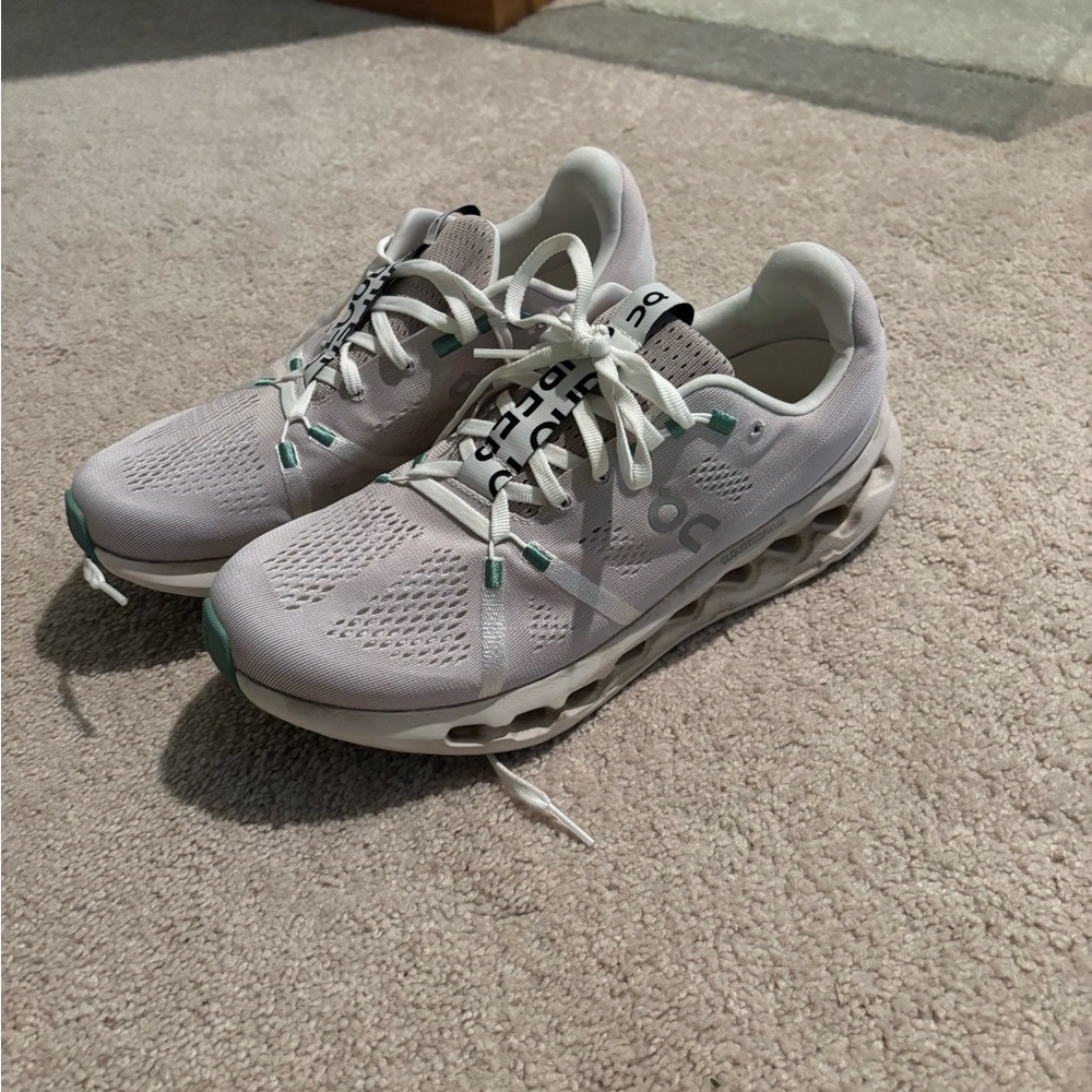 On Running White and Green Athletic Shoes